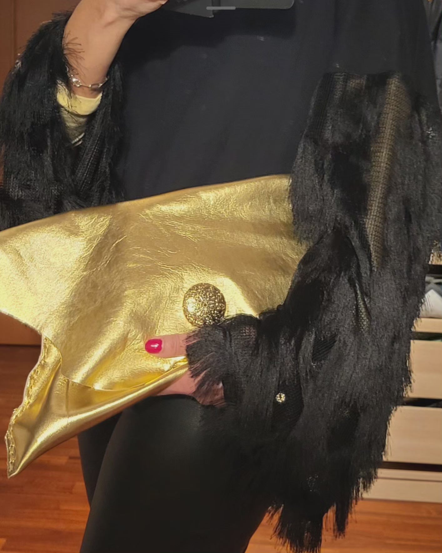 Gold colored clutch bag